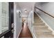 Inviting entryway with hardwood floors, staircase, and neutral walls, providing a warm welcome to the home at 6700 Roswell Rd # 19F, Atlanta, GA 30328