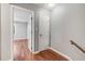 Hallway with hardwood floors leads to an open bedroom, offering seamless transition and bright space at 6700 Roswell Rd # 19F, Atlanta, GA 30328