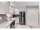Well-lit kitchen with white cabinets, granite countertops, and stainless steel appliances, offering a modern and functional space at 6700 Roswell Rd # 19F, Atlanta, GA 30328