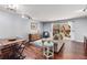 Open concept living room with hardwood floors, sliding glass door, and stylish decor, ideal for entertaining at 6700 Roswell Rd # 19F, Atlanta, GA 30328