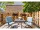 Small patio area with seating, flowers and a wooden fence for privacy at 6700 Roswell Rd # 19F, Atlanta, GA 30328