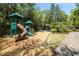 Community playground with a slide, climbing structure and wood chip base at 6700 Roswell Rd # 19F, Atlanta, GA 30328