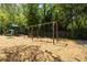 Community playground with swings, a slide and lush, mature landscaping at 6700 Roswell Rd # 19F, Atlanta, GA 30328