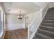 Bright dining room featuring modern hardwood floors, wainscoting, and a decorative chandelier at 1076 Field View Dr, Mcdonough, GA 30253