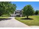 Inviting two-story home featuring a spacious front yard, a long driveway, and mature shade trees at 1076 Field View Dr, Mcdonough, GA 30253