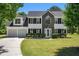 Charming two-story home with a well-manicured lawn, two-car garage, and beautiful landscaping at 1076 Field View Dr, Mcdonough, GA 30253