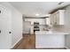 Modern kitchen featuring white cabinets, stainless steel appliances, and a breakfast bar at 1076 Field View Dr, Mcdonough, GA 30253