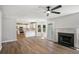 Open-concept living room featuring a fireplace, modern flooring, and a view of the kitchen at 1076 Field View Dr, Mcdonough, GA 30253