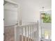 A staircase showcasing white railings and a decorative light fixture at 1076 Field View Dr, Mcdonough, GA 30253