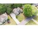 Aerial view of house with a long driveway and manicured lawn surrounded by lush trees and greenery at 1315 Woodland Trce, Cumming, GA 30041