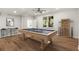 Finished basement featuring a billiard table, recessed lighting, and wood-style flooring at 1315 Woodland Trce, Cumming, GA 30041