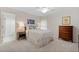Bedroom with a ceiling fan, light-colored walls, and adjoining bathroom at 1315 Woodland Trce, Cumming, GA 30041