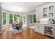 Charming dining area with lots of natural light, hardwood floors, and white cabinetry at 1315 Woodland Trce, Cumming, GA 30041