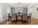 Dining room with hardwood floors, stylish light fixture, and seating for six at 1315 Woodland Trce, Cumming, GA 30041