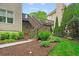 Exterior stairs to back deck with lush landscaping and mature trees at 1315 Woodland Trce, Cumming, GA 30041