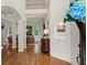 Bright foyer featuring hardwood floors, open staircase, and views into the living room at 1315 Woodland Trce, Cumming, GA 30041