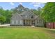 Beautiful home with a large front yard, stone accents, and an arched window adding character at 1315 Woodland Trce, Cumming, GA 30041