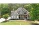 Charming two-story home with manicured lawn and inviting front porch at 1315 Woodland Trce, Cumming, GA 30041