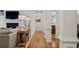 Inviting hallway featuring hardwood floors, decorative columns, and seamless flow into the living areas at 1315 Woodland Trce, Cumming, GA 30041