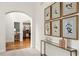 Elegant hallway with arched entrance, hardwood floors, console table and botanical artwork at 1315 Woodland Trce, Cumming, GA 30041