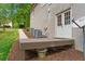 Rear exterior featuring a simple deck and entry with neatly mulched landscaping. Three AC Units are visible at 1315 Woodland Trce, Cumming, GA 30041