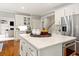 A kitchen island featuring white countertops, cabinets, and stainless steel appliances at 1315 Woodland Trce, Cumming, GA 30041