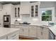 A gourmet kitchen featuring white cabinets, tile backsplash, and stainless steel appliances at 1315 Woodland Trce, Cumming, GA 30041