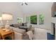 Bright living room featuring a cathedral ceiling, a comfortable sectional sofa and a large picture window at 1315 Woodland Trce, Cumming, GA 30041
