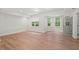 Spacious living room showcasing hardwood floors, recessed lighting, and a door leading to the outside at 1315 Woodland Trce, Cumming, GA 30041
