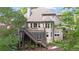 Beautiful rear exterior of house with a elevated deck, stairs, landscaped yard and a partial view of the backyard at 1315 Woodland Trce, Cumming, GA 30041