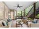 Spacious screened porch with ceiling fan and comfortable wicker seating, perfect for outdoor living at 1315 Woodland Trce, Cumming, GA 30041