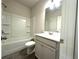 Bathroom with white shower-tub combo, grey floors and a grey vanity with white sink at 1608 Falcon Crest Way # 58, Decatur, GA 30032