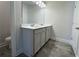 Bathroom featuring a dual sink vanity with modern fixtures and a grey tiled floor at 1608 Falcon Crest Way # 58, Decatur, GA 30032