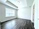Bright bedroom with tray ceilings, window and wood-look flooring at 1608 Falcon Crest Way # 58, Decatur, GA 30032