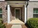 Charming front entrance with brick columns, a covered porch, and a view of the front yard at 1608 Falcon Crest Way # 58, Decatur, GA 30032
