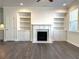 Bright living room featuring a fireplace, built-in shelving and hardwood floors at 1608 Falcon Crest Way # 58, Decatur, GA 30032