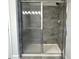 Glass-enclosed shower with a grey tiled surround and modern shower head at 1608 Falcon Crest Way # 58, Decatur, GA 30032