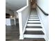 Staircase with hardwood treads and white risers, leading to the upper level at 1608 Falcon Crest Way # 58, Decatur, GA 30032