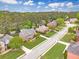 Neighborhood street view showcasing a brick home with a manicured lawn and mature trees at 1611 Threepine Pl, Lilburn, GA 30047