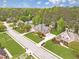 Neighborhood street view showcasing a brick home with a manicured lawn and mature trees at 1611 Threepine Pl, Lilburn, GA 30047