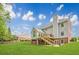 Exterior view of home with a spacious backyard, a deck, and stairs leading to the yard at 1611 Threepine Pl, Lilburn, GA 30047