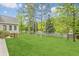 Spacious backyard with a well-maintained lawn and mature trees, providing a serene outdoor space at 1611 Threepine Pl, Lilburn, GA 30047