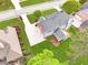 Aerial shot of home's backyard with patio, green lawn, and well-manicured landscaping at 1611 Threepine Pl, Lilburn, GA 30047
