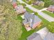 Aerial view of a brick home with a backyard, deck, and well-maintained landscaping at 1611 Threepine Pl, Lilburn, GA 30047