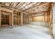 Unfinished basement featuring exposed beams and concrete flooring, offering potential for customization at 1611 Threepine Pl, Lilburn, GA 30047