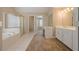 Bright bathroom with a tub, shower, vanity, and tile flooring at 1611 Threepine Pl, Lilburn, GA 30047
