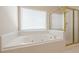 Bathroom with a large tub and a glass enclosed shower at 1611 Threepine Pl, Lilburn, GA 30047