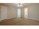 Spacious bedroom with tan walls, neutral carpet and open bathroom at 1611 Threepine Pl, Lilburn, GA 30047