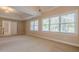 Large bedroom with vaulted ceilings and large window letting in lots of light at 1611 Threepine Pl, Lilburn, GA 30047