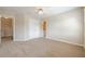 Spacious carpeted bedroom featuring a ceiling fan and closet for storage at 1611 Threepine Pl, Lilburn, GA 30047